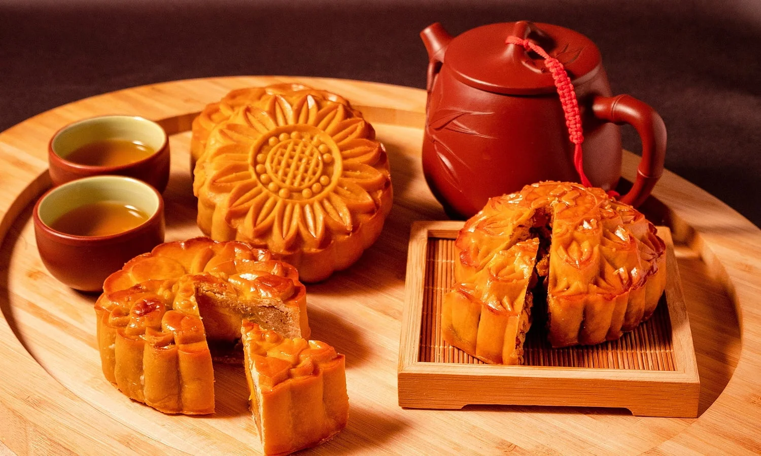 Bánh trung thu đặt trên khay cùng ấm trà đỏ