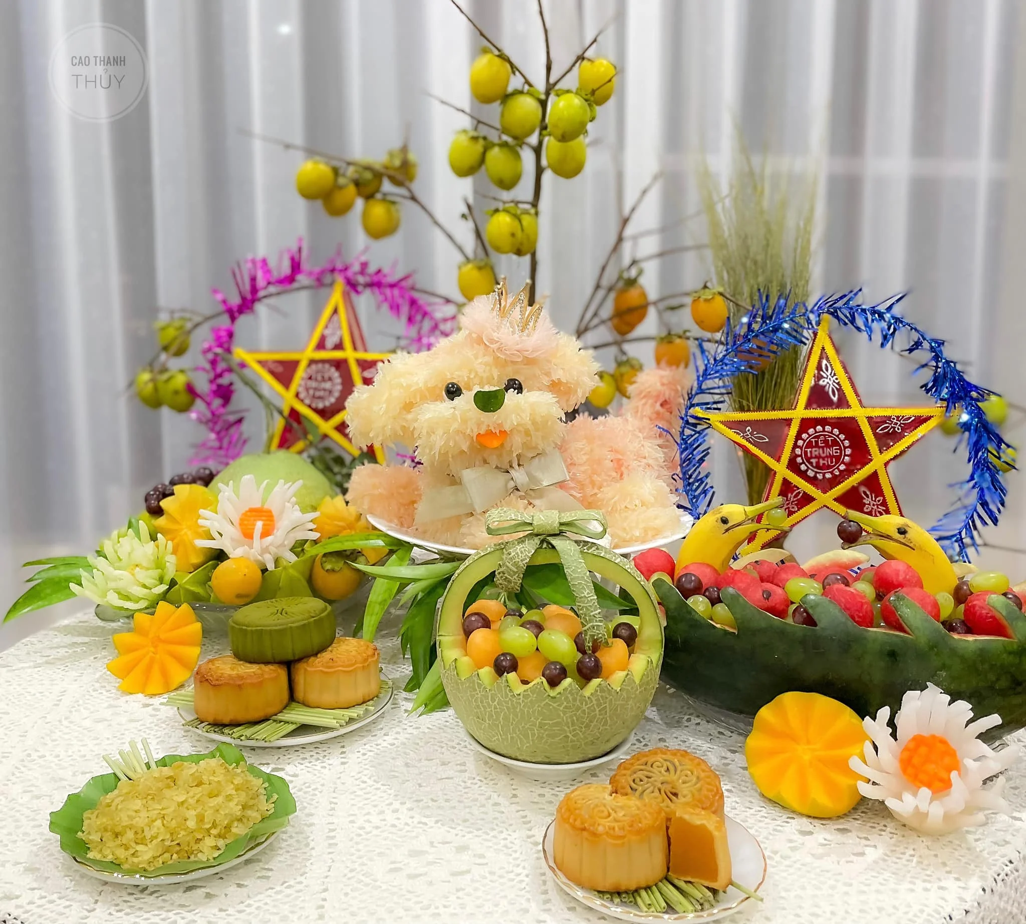 Mâm cỗ Trung Thu với bánh nướng, trái cây, hoa và đèn ông sao